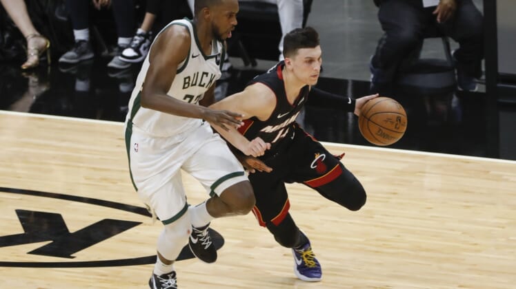 May 29, 2021; Miami, Florida, USA; Miami Heat guard Tyler Herro (14) dribbles the basketball around Milwaukee Bucks forward Khris Middleton (22) during the second quarter of game four in the first round of the 2021 NBA Playoffs at American Airlines Arena. Mandatory Credit: Sam Navarro-USA TODAY Sports