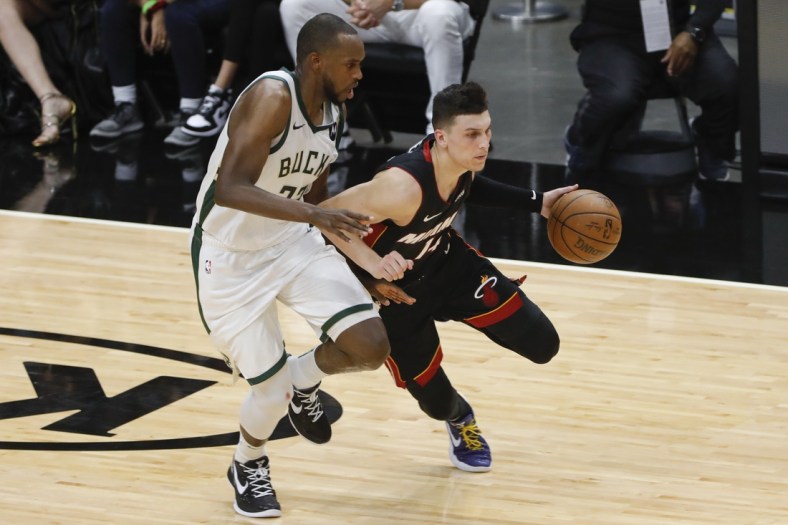 May 29, 2021; Miami, Florida, USA; Miami Heat guard Tyler Herro (14) dribbles the basketball around Milwaukee Bucks forward Khris Middleton (22) during the second quarter of game four in the first round of the 2021 NBA Playoffs at American Airlines Arena. Mandatory Credit: Sam Navarro-USA TODAY Sports
