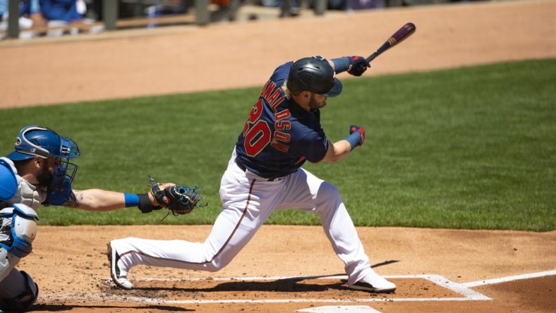 May 29, 2021; Minneapolis, Minnesota, USA; Minnesota Twins third baseman Josh Donaldson (20) hits a single during the first inning against the Kansas City Royals at Target Field. Mandatory Credit: Jordan Johnson-USA TODAY Sports