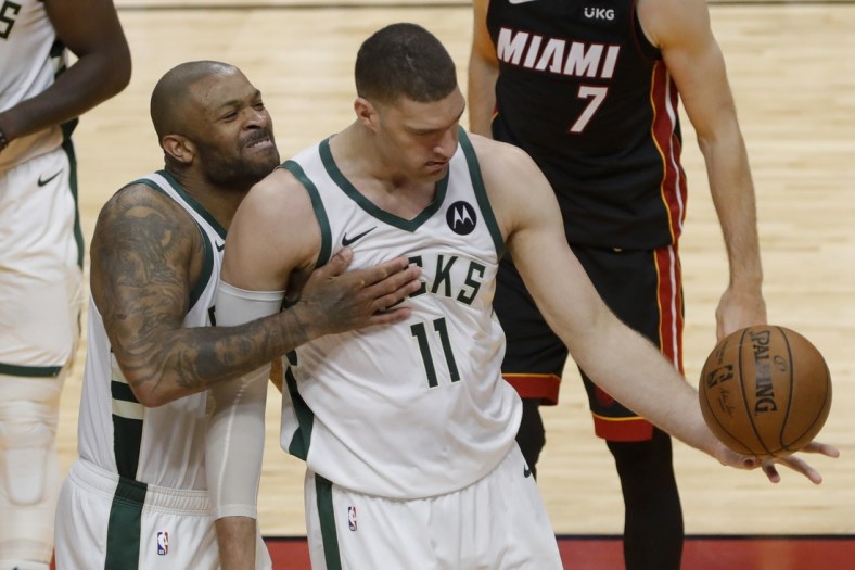 May 29, 2021; Miami, Florida, USA; Milwaukee Bucks forward P.J. Tucker (17) celebrates with center Brook Lopez (11) after scoring against the Miami Heat during the fourth quarter of game four in the first round of the 2021 NBA Playoffs at American Airlines Arena. Mandatory Credit: Sam Navarro-USA TODAY Sports