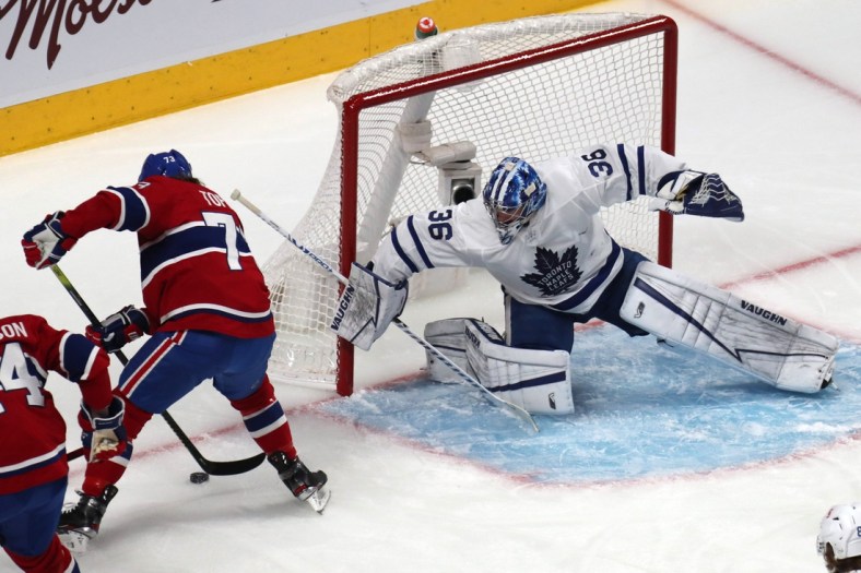 May 29, 2021; Montreal, Quebec, CAN; Montreal Canadiens right wing Tyler Toffoli (73) plays the puck next to Toronto Maple Leafs goaltender Jack Campbell (36) during the first period in game six of the first round of the 2021 Stanley Cup Playoffs at Bell Centre. Mandatory Credit: Jean-Yves Ahern-USA TODAY Sports