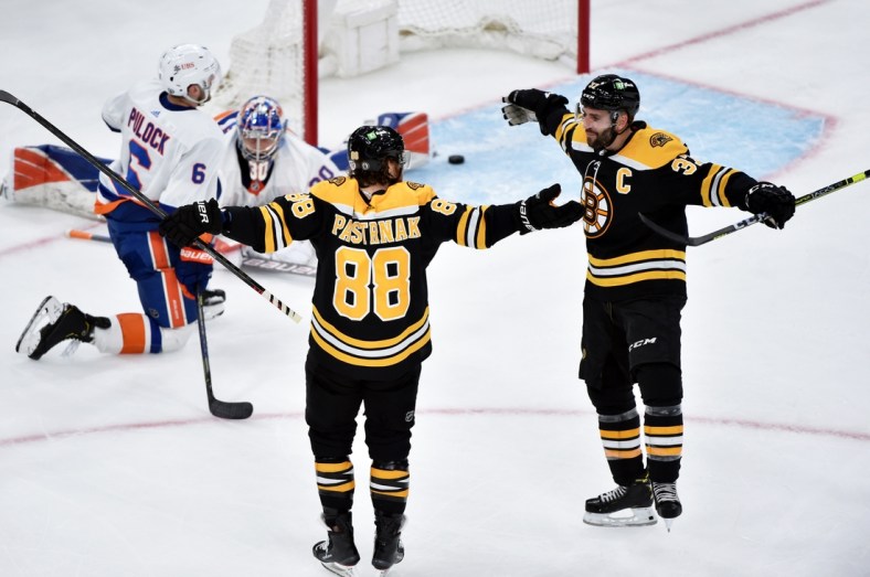 May 29, 2021; Boston, MA, USA; Boston Bruins right wing David Pastrnak (88) reacts with center Patrice Bergeron (37) after scoring his second goal of the game during the second period in game one of the second round of the 2021 Stanley Cup Playoffs against the New York Islanders at TD Garden. Mandatory Credit: Bob DeChiara-USA TODAY Sports