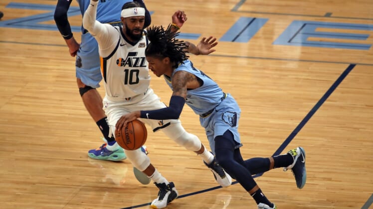 May 29, 2021; Memphis, Tennessee, USA; Memphis Grizzlies guard Ja Morant (12) dribbles around Utah Jazz guard Mike Conley (10) during the fourth quarter during game three in the first round of the 2021 NBA Playoffs at FedExForum. Mandatory Credit: Petre Thomas-USA TODAY Sports