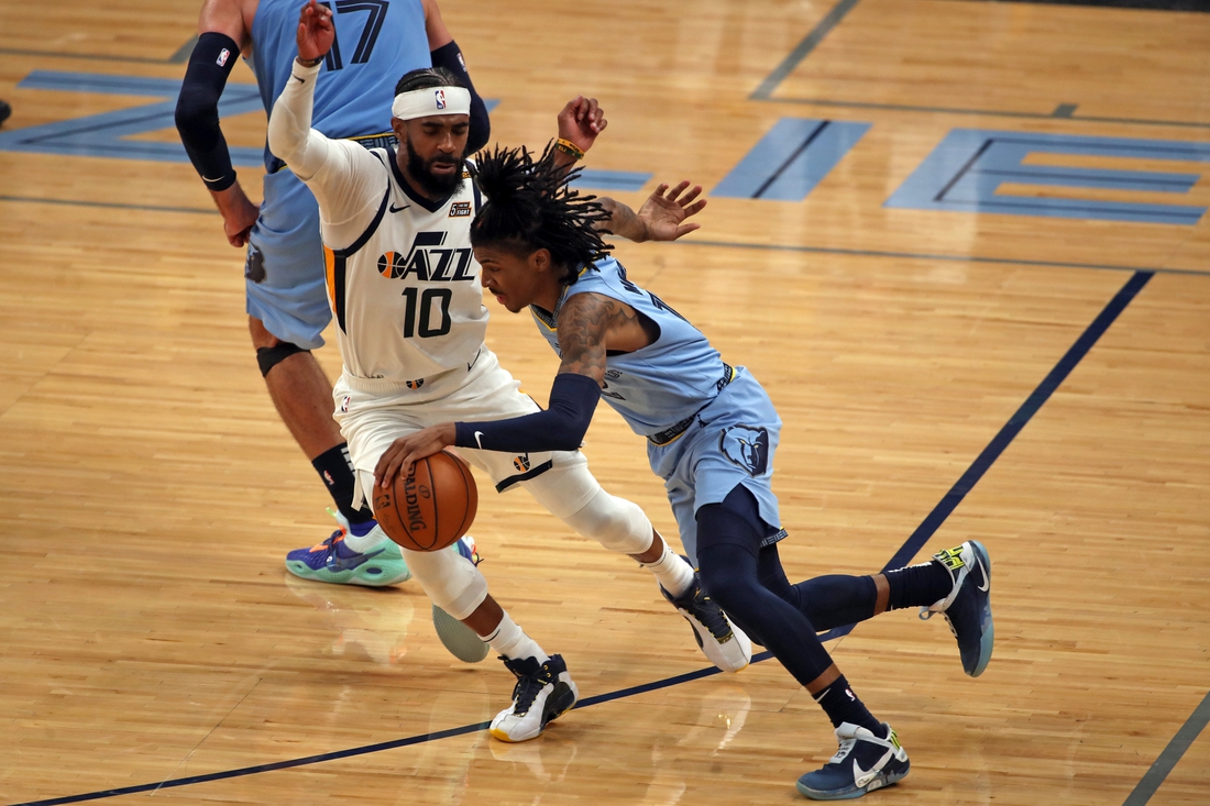 May 29, 2021; Memphis, Tennessee, USA; Memphis Grizzlies guard Ja Morant (12) dribbles around Utah Jazz guard Mike Conley (10) during the fourth quarter during game three in the first round of the 2021 NBA Playoffs at FedExForum. Mandatory Credit: Petre Thomas-USA TODAY Sports