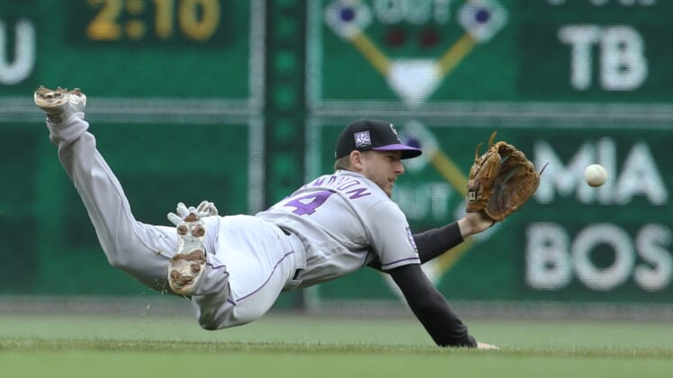 May 30, 2021; Pittsburgh, Pennsylvania, USA; Colorado Rockies second baseman Ryan McMahon (24) makes a diving stop on a ball hit by Pittsburgh Pirates third baseman Erik Gonzalez (not pictured) during the second inning at PNC Park. Mandatory Credit: Charles LeClaire-USA TODAY Sports