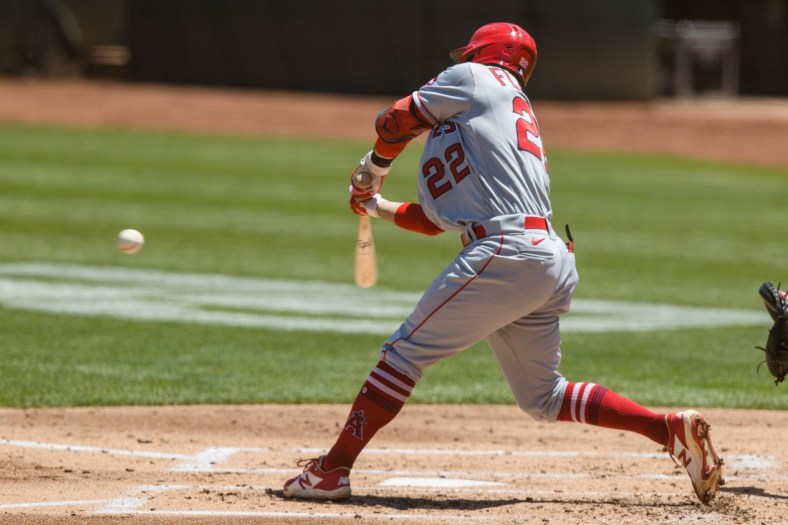 May 30, 2021; Oakland, California, USA; Los Angeles Angels shortstop David Fletcher (22) hits a two-RBI double against the Oakland Athletics during the second inning at RingCentral Coliseum. Mandatory Credit: John Hefti-USA TODAY Sports