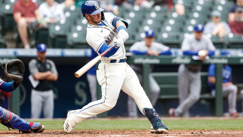 May 30, 2021; Seattle, Washington, USA; Seattle Mariners first baseman Ty France (23) hits an RBI double against the Texas Rangers during the first inning at T-Mobile Park. Mandatory Credit: Jennifer Buchanan-USA TODAY Sports