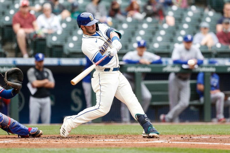 May 30, 2021; Seattle, Washington, USA; Seattle Mariners first baseman Ty France (23) hits an RBI double against the Texas Rangers during the first inning at T-Mobile Park. Mandatory Credit: Jennifer Buchanan-USA TODAY Sports