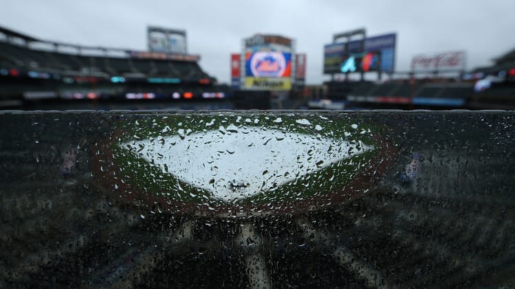 May 30, 2021; New York City, New York, USA; General view of a tarp on the field as rain falls at Citi Field. Tonight's game between the New York Mets and the Atlanta Braves has been postponed due to inclement weather. Mandatory Credit: Brad Penner-USA TODAY Sports
