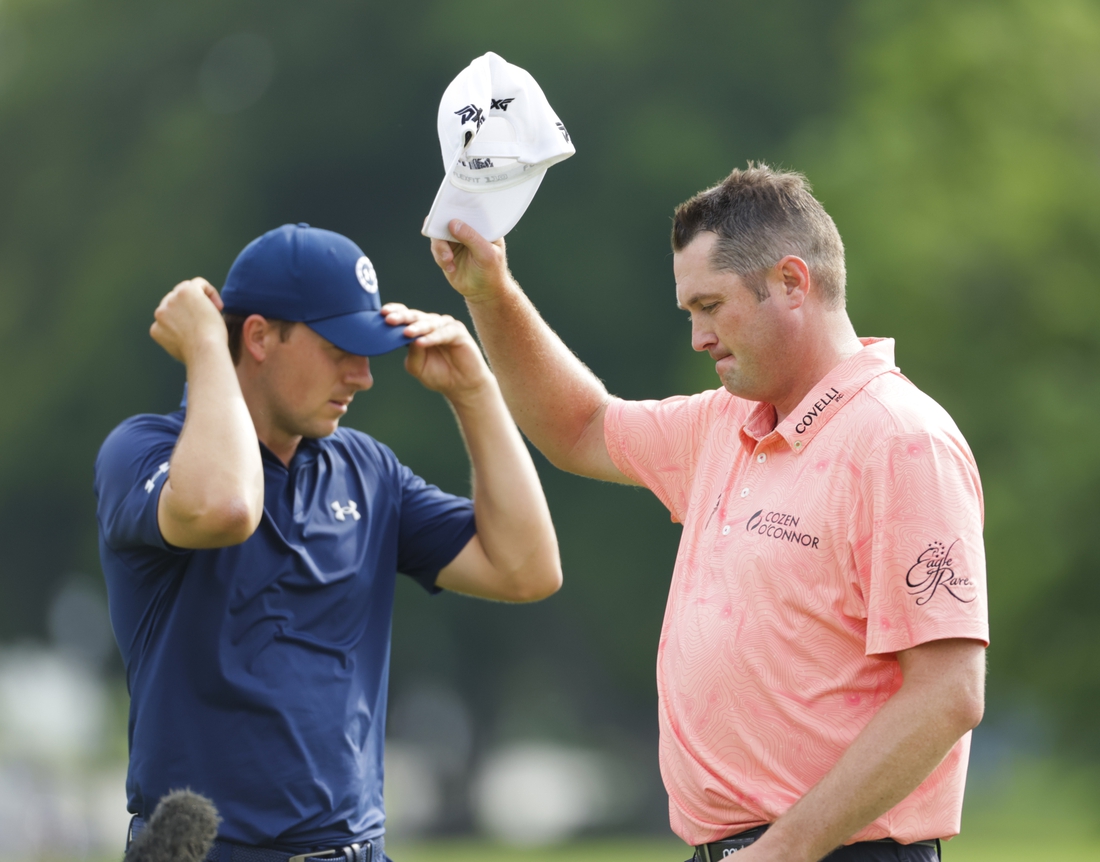 May 30, 2021; Fort Worth, Texas, USA; Charles Schwab Challenge winner Jason Kokrak tips his cap to the crowd after beating runner-up Jordan Spieth in the final round of the Charles Schwab Challenge golf tournament. Mandatory Credit: Erich Schlegel-USA TODAY Sports