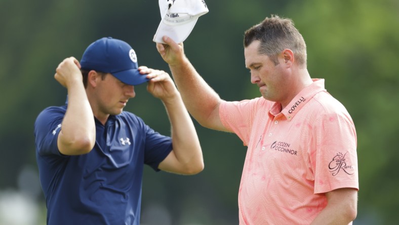 May 30, 2021; Fort Worth, Texas, USA; Charles Schwab Challenge winner Jason Kokrak tips his cap to the crowd after beating runner-up Jordan Spieth in the final round of the Charles Schwab Challenge golf tournament. Mandatory Credit: Erich Schlegel-USA TODAY Sports