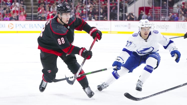 May 30, 2021; Raleigh, North Carolina, USA; Carolina Hurricanes center Martin Necas (88) takes a shot against Tampa Bay Lightning center Yanni Gourde (37) in game one of the second round of the 2021 Stanley Cup Playoffs at PNC Arena. Mandatory Credit: James Guillory-USA TODAY Sports