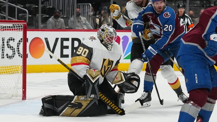May 30, 2021; Denver, Colorado, USA; Vegas Golden Knights goaltender Robin Lehner (90) defends his net from left wing Brandon Saad (20) in the first period of game one in the second round of the 2021 Stanley Cup Playoffs at Ball Arena. Mandatory Credit: Ron Chenoy-USA TODAY Sports