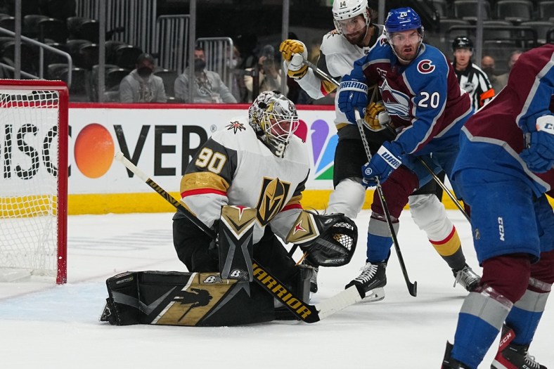 May 30, 2021; Denver, Colorado, USA; Vegas Golden Knights goaltender Robin Lehner (90) defends his net from left wing Brandon Saad (20) in the first period of game one in the second round of the 2021 Stanley Cup Playoffs at Ball Arena. Mandatory Credit: Ron Chenoy-USA TODAY Sports