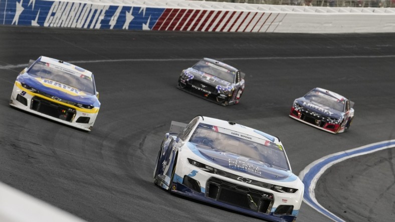 May 30, 2021; Concord, North Carolina, USA; NASCAR Cup Series driver Kyle Larson (5) fends off driver Chase Elliott (9) during the Coca-Cola 600 at Charlotte Motor Speedway. Mandatory Credit: Jim Dedmon-USA TODAY Sports