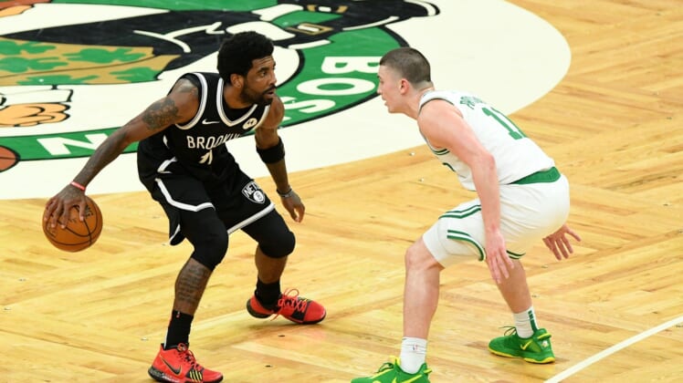 May 30, 2021; Boston, Massachusetts, USA; Brooklyn Nets guard Kyrie Irving (11) controls the ball in front of Boston Celtics guard Payton Pritchard (11) during the second half of game four in the first round of the 2021 NBA Playoffs. at TD Garden. Mandatory Credit: Brian Fluharty-USA TODAY Sports