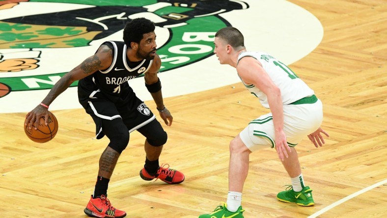 May 30, 2021; Boston, Massachusetts, USA; Brooklyn Nets guard Kyrie Irving (11) controls the ball in front of Boston Celtics guard Payton Pritchard (11) during the second half of game four in the first round of the 2021 NBA Playoffs. at TD Garden. Mandatory Credit: Brian Fluharty-USA TODAY Sports