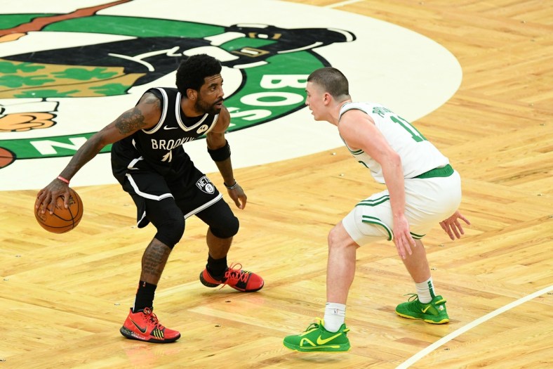 May 30, 2021; Boston, Massachusetts, USA; Brooklyn Nets guard Kyrie Irving (11) controls the ball in front of Boston Celtics guard Payton Pritchard (11) during the second half of game four in the first round of the 2021 NBA Playoffs. at TD Garden. Mandatory Credit: Brian Fluharty-USA TODAY Sports