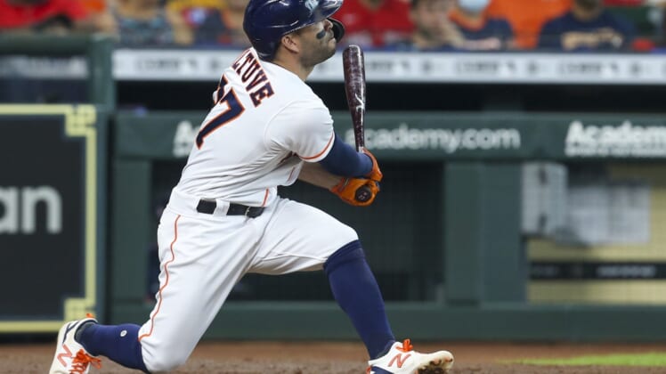 May 31, 2021; Houston, Texas, USA; Houston Astros second baseman Jose Altuve (27) hits a two run home run against the Boston Red Sox in the third inning at Minute Maid Park. Mandatory Credit: Thomas Shea-USA TODAY Sports