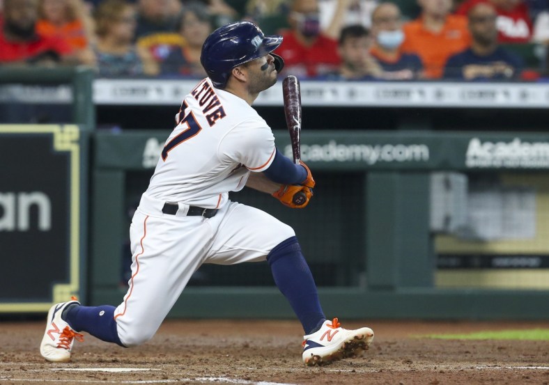 May 31, 2021; Houston, Texas, USA; Houston Astros second baseman Jose Altuve (27) hits a two run home run against the Boston Red Sox in the third inning at Minute Maid Park. Mandatory Credit: Thomas Shea-USA TODAY Sports