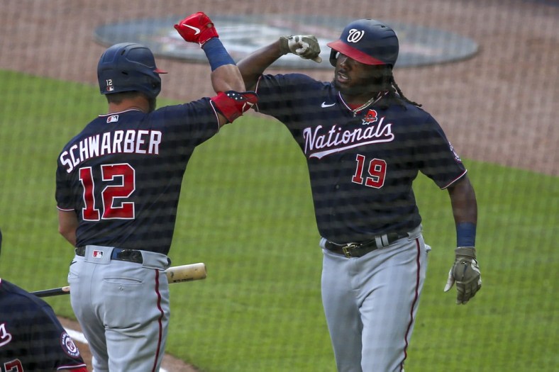 May 31, 2021; Atlanta, Georgia, USA; Washington Nationals first baseman Josh Bell (19) celebrates after a home run with left fielder Kyle Schwarber (12) against the Atlanta Braves in the fourth inning at Truist Park. Mandatory Credit: Brett Davis-USA TODAY Sports
