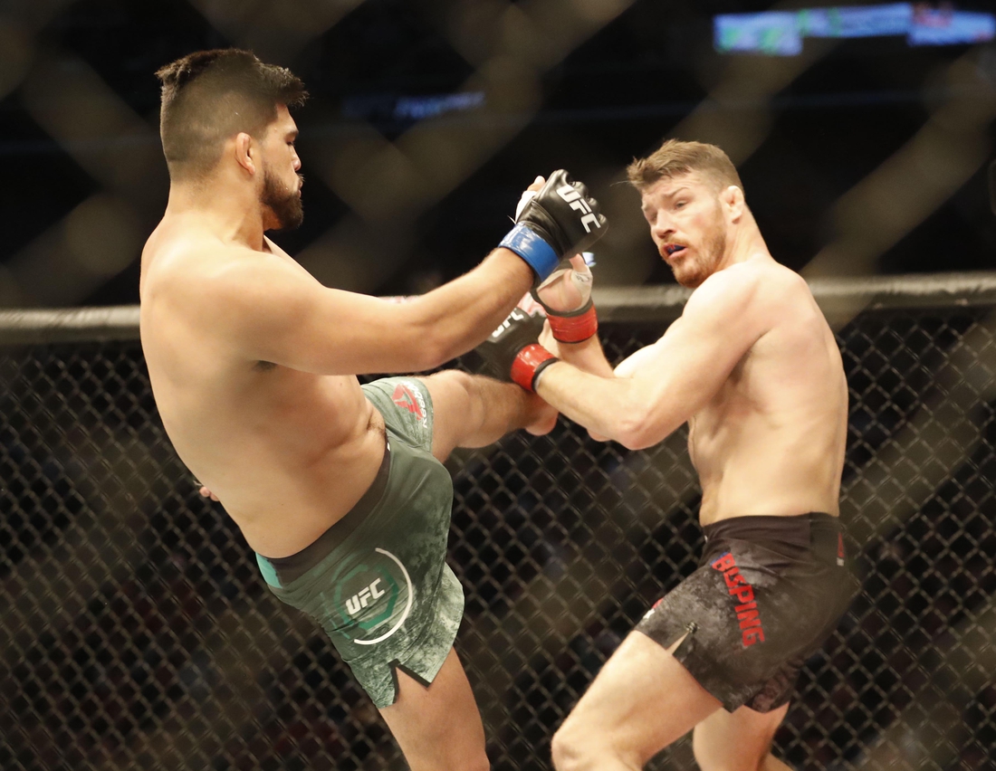 Nov 25, 2017; Shanghai, China; Kelvin Gastelum (blue gloves) fights Michael Bisping (red gloves) during UFC Fight Night at Mercedes-Benz Arena. Mandatory Credit: David G. McIntyre-USA TODAY Sports