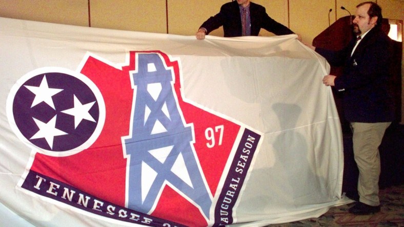 David Goldman, of NFL properties, left, and Alan Reitano drape a banner with the new Tennessee Oilers logo over a table before it is unveiled in Nashville June 12, 1997. The banner was placed over the table after it fell down from the wall. The Oilers will use the new logo during their inaugural season in Tennessee this year.

Houston Oilers