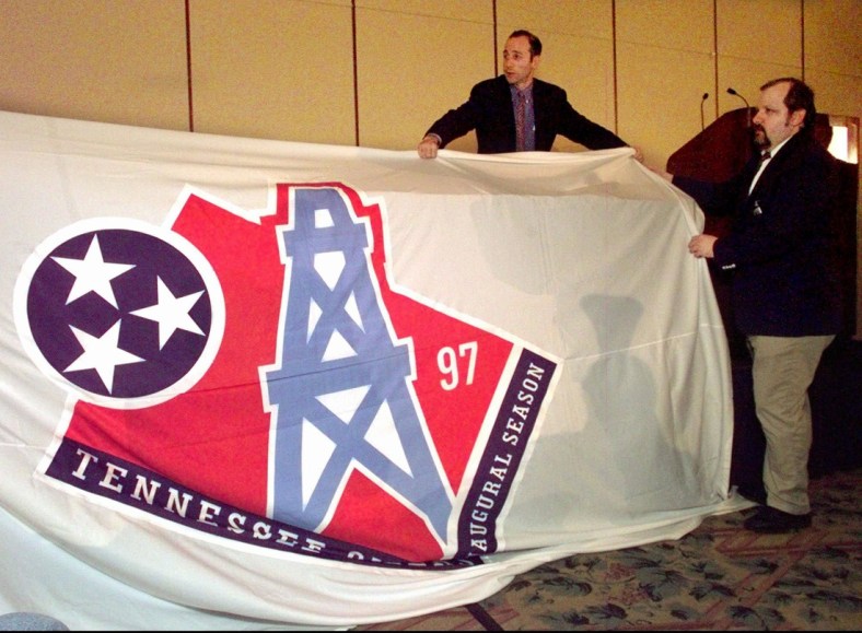 David Goldman, of NFL properties, left, and Alan Reitano drape a banner with the new Tennessee Oilers logo over a table before it is unveiled in Nashville June 12, 1997. The banner was placed over the table after it fell down from the wall. The Oilers will use the new logo during their inaugural season in Tennessee this year.

Houston Oilers