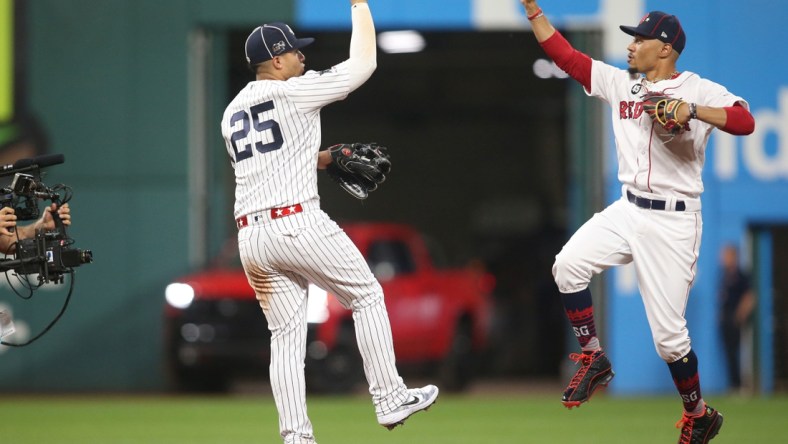 Jul 9, 2019; Cleveland, OH, USA;  American League second baseman Gleyber Torres (25) of the New York Yankees and center fielder Mookie Betts (50) of the Boston Red Sox celebrate after defeating the National League in the 2019 MLB All Star Game at Progressive Field. Mandatory Credit: Charles LeClaire-USA TODAY Sports