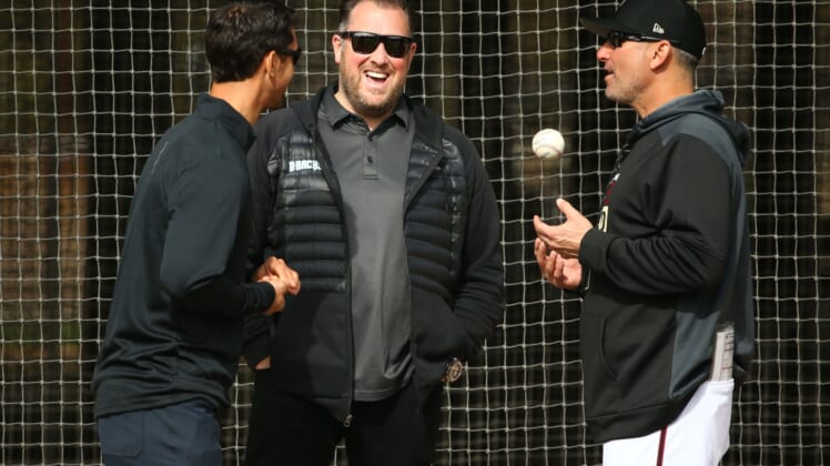Diamondbacks GM Mike Hazen, senior vice president and assistant GM Jared Porter (center) and manager Torey Lovullo talk during the first day of spring training workouts on Feb. 13 at Salt River Fields.Arizona Diamondbacks Spring Training