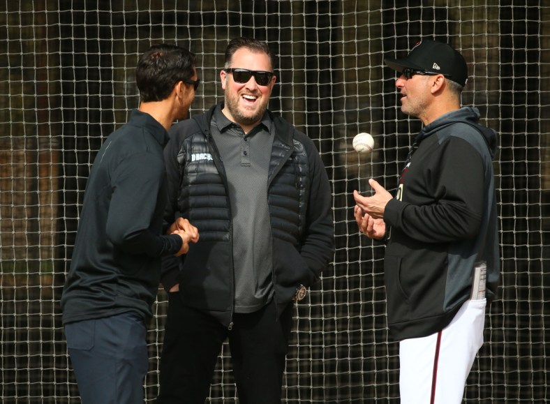 Diamondbacks GM Mike Hazen, senior vice president and assistant GM Jared Porter (center) and manager Torey Lovullo talk during the first day of spring training workouts on Feb. 13 at Salt River Fields.

Arizona Diamondbacks Spring Training