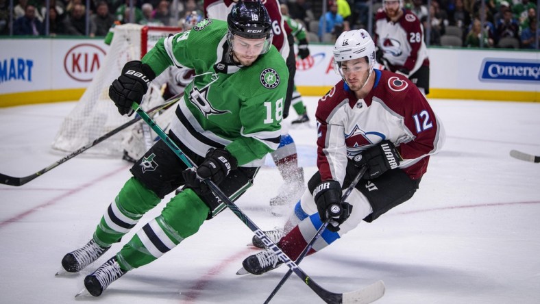 Nov 5, 2019; Dallas, TX, USA; Dallas Stars center Jason Dickinson (18) and Colorado Avalanche center Jayson Megna (12) chase the puck during the second period at the American Airlines Center. Mandatory Credit: Jerome Miron-USA TODAY Sports