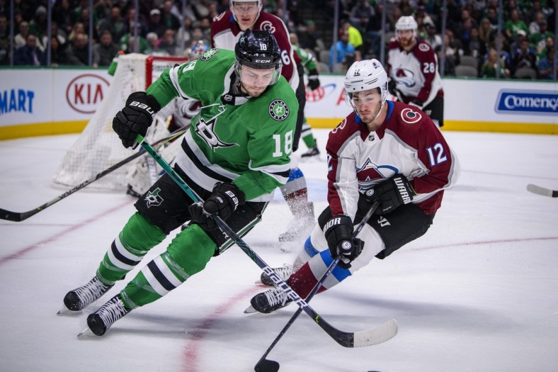 Nov 5, 2019; Dallas, TX, USA; Dallas Stars center Jason Dickinson (18) and Colorado Avalanche center Jayson Megna (12) chase the puck during the second period at the American Airlines Center. Mandatory Credit: Jerome Miron-USA TODAY Sports