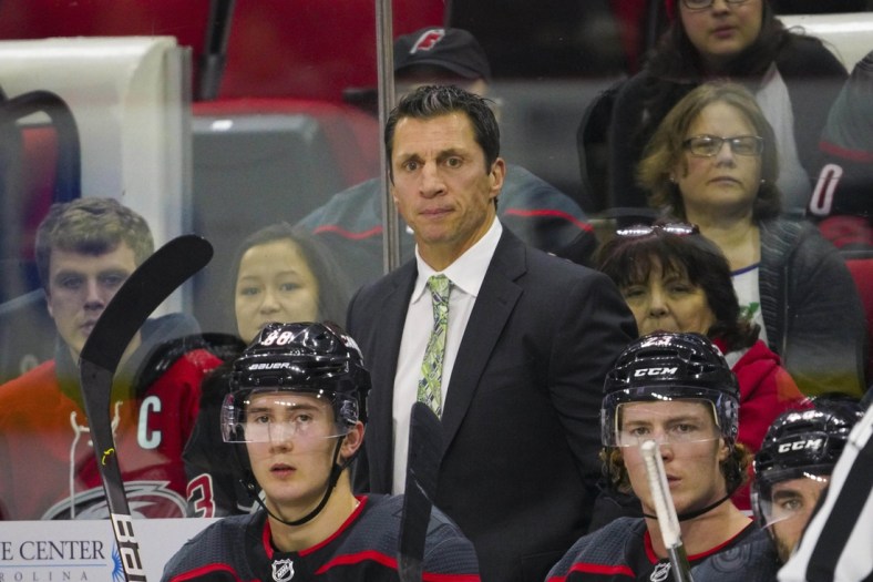 Dec 31, 2019; Raleigh, North Carolina, USA;  Carolina Hurricanes head coach Rod Brind'Amour looks on from behind the players bench against the Montreal Canadiens at PNC Arena. The Carolina Hurricanes defeated the Montreal Canadiens 3-1. Mandatory Credit: James Guillory-USA TODAY Sports