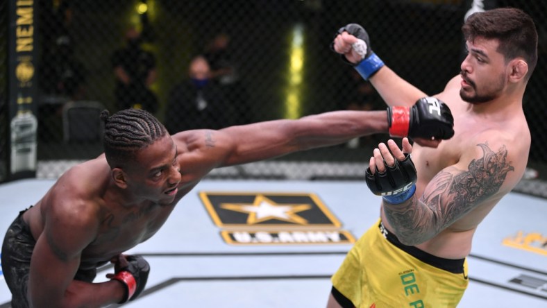 May 30, 2020; Las Vegas, NV, USA; Jamahal Hill (red gloves) punches Klidson Abreu of Brazil (blue gloves) in their light heavyweight fight during UFC Fight Night.  Mandatory Credit: Jeff Bottari/Zuffa via USA TODAY Sports