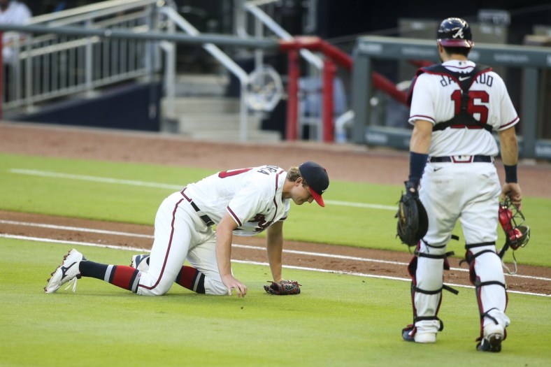 Aug 3, 2020; Atlanta, Georgia, USA; Atlanta Braves starting pitcher Mike Soroka (40) on the ground with an injury as catcher Travis d'Arnaud (16) looks on against the New York Mets in the third inning at Truist Park. Mandatory Credit: Brett Davis-USA TODAY Sports