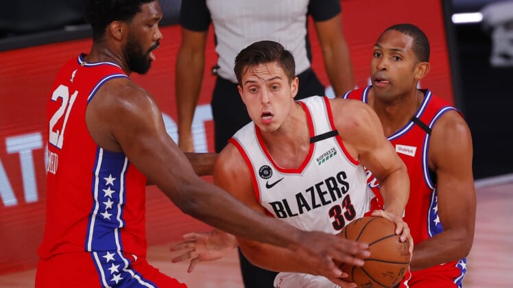 Aug 9, 2020; Lake Buena Vista, Florida, USA;  Zach Collins #33 of the Portland Trail Blazers is pressured by Joel Embiid #21 of the Philadelphia 76ers at Visa Athletic Center at ESPN Wide World Of Sports Complex on August 09, 2020 in Lake Buena Vista, Florida.  Mandatory Credit: Kevin C. Cox/Pool Photo-USA TODAY Sports