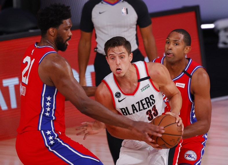 Aug 9, 2020; Lake Buena Vista, Florida, USA;  Zach Collins #33 of the Portland Trail Blazers is pressured by Joel Embiid #21 of the Philadelphia 76ers at Visa Athletic Center at ESPN Wide World Of Sports Complex on August 09, 2020 in Lake Buena Vista, Florida.  Mandatory Credit: Kevin C. Cox/Pool Photo-USA TODAY Sports