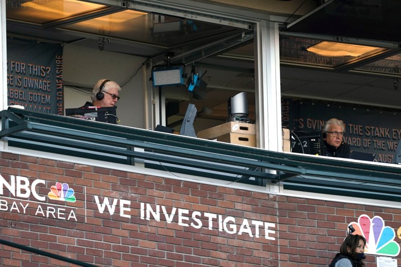 Aug 1, 2020; San Francisco, California, USA; NBC Sports Bay Area television announcers Mike Krukow (left) and Duane Kuiper call the game from different booths during the first inning of the game between the San Francisco Giants and the Texas Rangers at Oracle Park. Mandatory Credit: Darren Yamashita-USA TODAY Sports