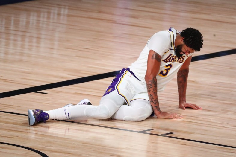 Sep 8, 2020; Lake Buena Vista, Florida, USA; Los Angeles Lakers forward Anthony Davis (3) lies on the floor after suffering an apparent injury with Houston Rockets forward Robert Covington (not picture) during the second half of game three in the second round of the 2020 NBA Playoffs at AdventHealth Arena. Mandatory Credit: Kim Klement-USA TODAY Sports