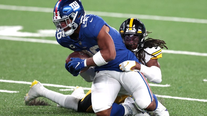 Sep 14, 2020; East Rutherford, New Jersey, USA; New York Giants running back Saquon Barkley (26) is tackled by Pittsburgh Steelers strong safety Terrell Edmunds (34) during the second half at MetLife Stadium. Mandatory Credit: Vincent Carchietta-USA TODAY Sports