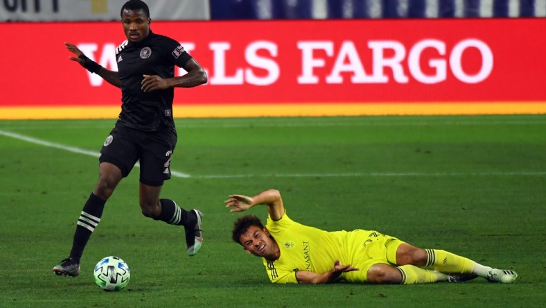 Nov 20, 2020; Nashville, TN, Nashville, TN, USA; Inter Miami defender Alvas Powell (2) takes the ball from Nashville SC defender Taylor Washington (23) during the second half at Nissan Stadium. Mandatory Credit: Christopher Hanewinckel-USA TODAY Sports