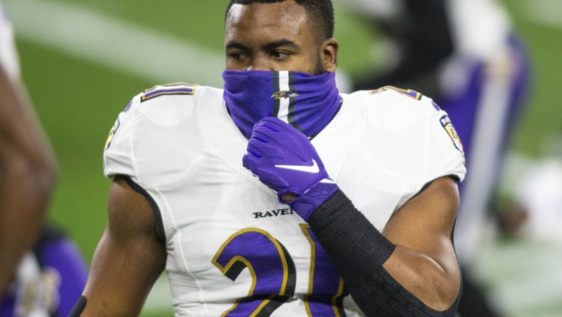 Dec 14, 2020; Cleveland, Ohio, USA; Baltimore Ravens running back Mark Ingram (21) adjusts his face mask before the game against the Cleveland Browns at FirstEnergy Stadium. Mandatory Credit: Scott Galvin-USA TODAY Sports