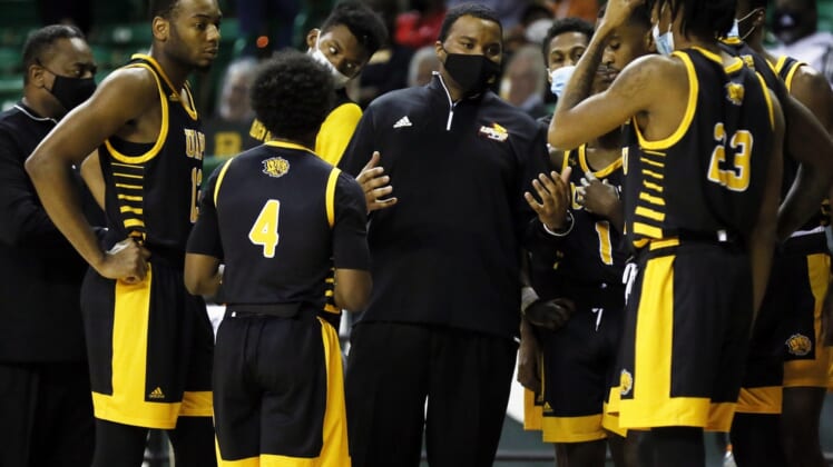 Dec 21, 2020; Waco, Texas, USA; Arkansas-Pine Bluff Golden Lions head coach George Ivory huddles with his team during the second half against the Baylor Bears at Ferrell Center. Mandatory Credit: Raymond Carlin III-USA TODAY Sports