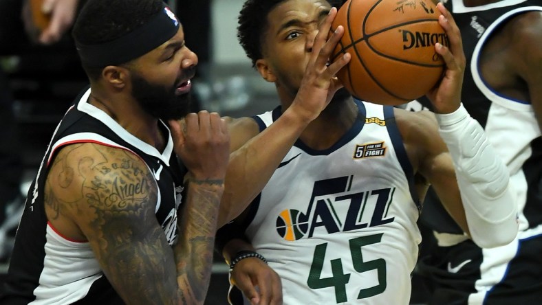 Feb 19, 2021; Los Angeles, California, USA; Los Angeles Clippers forward Marcus Morris Sr. (8) defends Utah Jazz guard Donovan Mitchell (45) as he drives to the basket in the second half of the game at Staples Center. Mandatory Credit: Jayne Kamin-Oncea-USA TODAY Sports