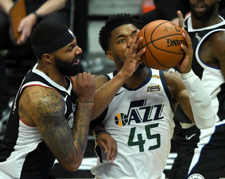 Feb 19, 2021; Los Angeles, California, USA; Los Angeles Clippers forward Marcus Morris Sr. (8) defends Utah Jazz guard Donovan Mitchell (45) as he drives to the basket in the second half of the game at Staples Center. Mandatory Credit: Jayne Kamin-Oncea-USA TODAY Sports