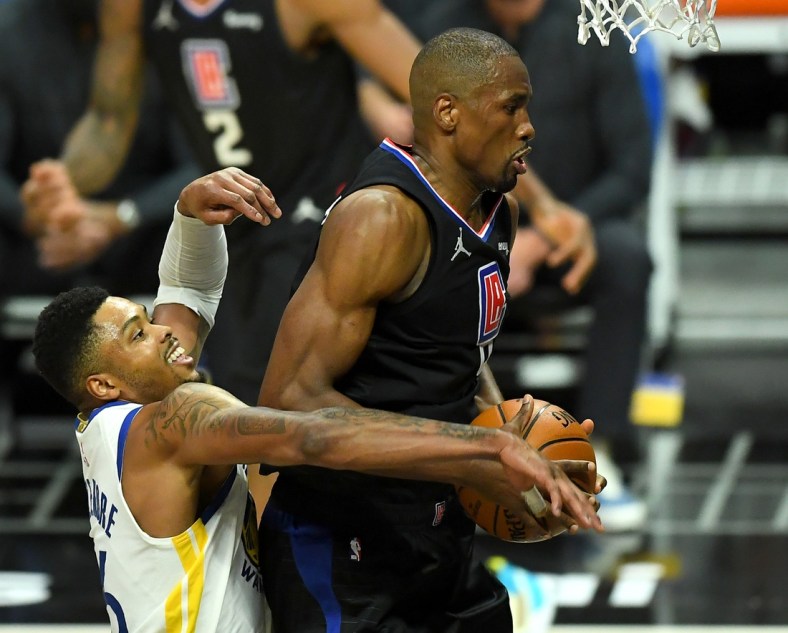 Mar 11, 2021; Los Angeles, California, USA;  Los Angeles Clippers center Serge Ibaka (9) is fouled by Golden State Warriors forward Kent Bazemore (26) as he goes up for a basket in the second half of the game at Staples Center. Mandatory Credit: Jayne Kamin-Oncea-USA TODAY Sports
