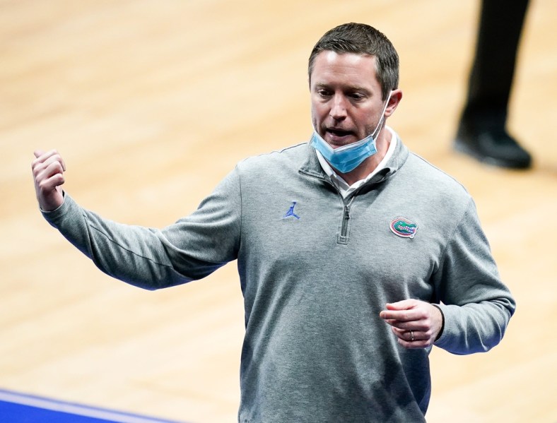 Florida head coach Mike White works with his team during the first half of the SEC Men's Basketball Tournament game against Tennessee at Bridgestone Arena in Nashville, Tenn., Friday, March 12, 2021.

Ut Fla Sec 031221 An 014