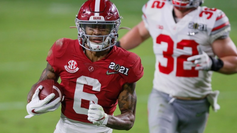 Alabama receiver DeVonta Smith catches a 42-yard touchdown behind Ohio State linebacker Tuf Borland during the second quarter of the College Football Playoff National Championship Game, Jan. 11, 2021 in Miami Gardens, Fla.

Ncaa Football Cfp National Championship Ohio State Vs Alabama