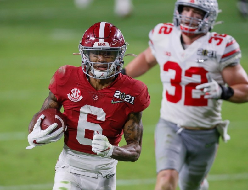 Alabama receiver DeVonta Smith catches a 42-yard touchdown behind Ohio State linebacker Tuf Borland during the second quarter of the College Football Playoff National Championship Game, Jan. 11, 2021 in Miami Gardens, Fla.

Ncaa Football Cfp National Championship Ohio State Vs Alabama